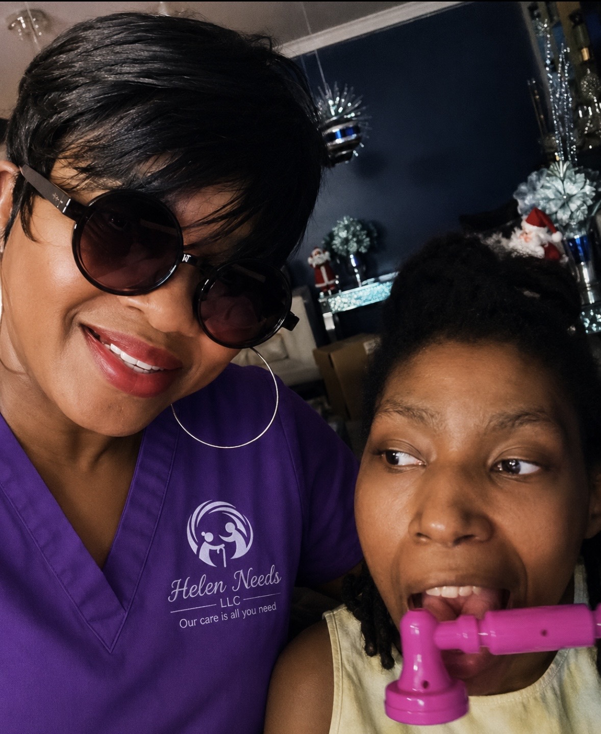 Breyata Battle in her Helen Needs uniform sharing a joyful moment with a community member