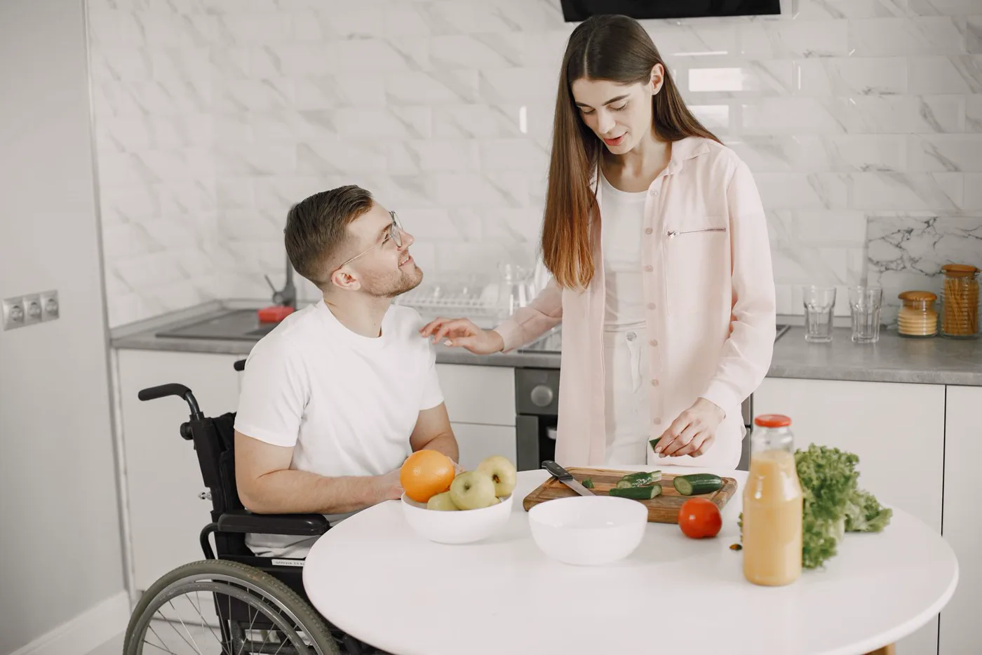 Two adults preparing fresh food together in an accessible kitchen